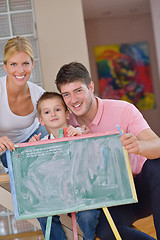 Image showing family drawing on school board at home