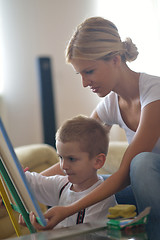 Image showing family drawing on school board at home