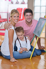 Image showing family drawing on school board at home