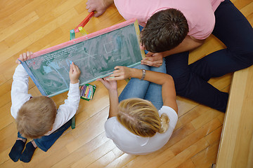 Image showing family drawing on school board at home