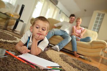 Image showing family drawing on school board at home