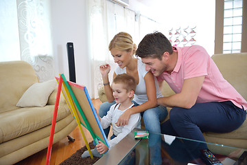 Image showing family drawing on school board at home