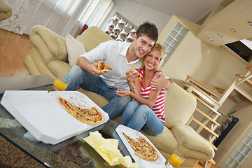 Image showing couple at home eating  pizza