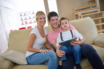 Image showing family at home using tablet computer