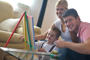 Image showing family drawing on school board at home