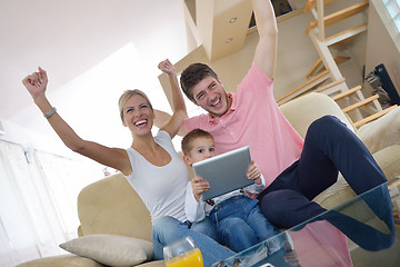 Image showing family at home using tablet computer