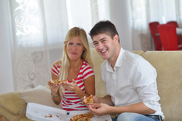 Image showing couple at home eating  pizza