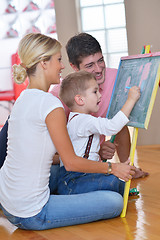 Image showing family drawing on school board at home