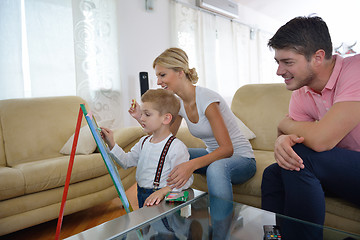 Image showing family drawing on school board at home