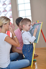 Image showing family drawing on school board at home