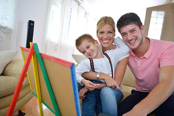 Image showing family drawing on school board at home