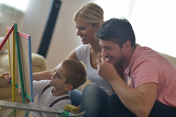 Image showing family drawing on school board at home