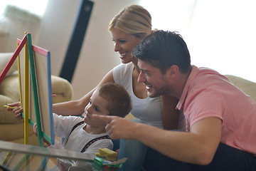 Image showing family drawing on school board at home