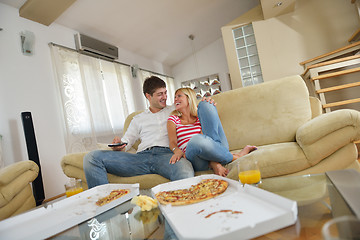 Image showing couple at home eating  pizza