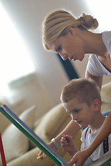 Image showing family drawing on school board at home