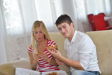 Image showing couple at home eating  pizza