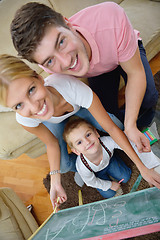 Image showing family drawing on school board at home