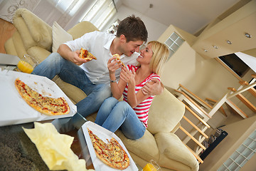 Image showing couple at home eating  pizza