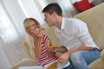 Image showing couple at home eating  pizza