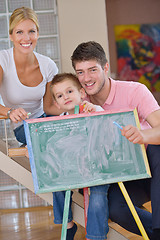 Image showing family drawing on school board at home