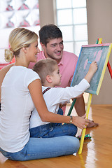 Image showing family drawing on school board at home