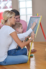 Image showing family drawing on school board at home