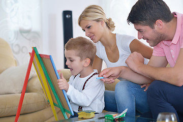 Image showing family drawing on school board at home