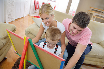 Image showing family drawing on school board at home