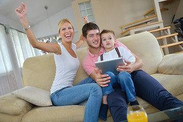 Image showing family at home using tablet computer