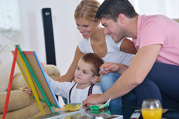 Image showing family drawing on school board at home