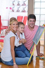 Image showing family drawing on school board at home