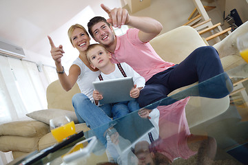 Image showing family at home using tablet computer