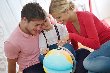 Image showing family have fun with globe