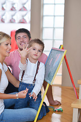 Image showing family drawing on school board at home