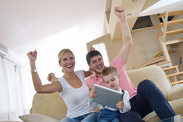 Image showing family at home using tablet computer