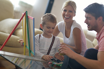 Image showing family drawing on school board at home