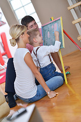 Image showing family drawing on school board at home