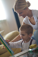 Image showing family drawing on school board at home