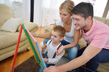 Image showing family drawing on school board at home