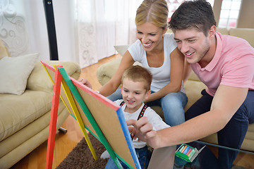 Image showing family drawing on school board at home