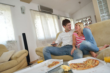 Image showing couple at home eating  pizza