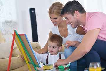 Image showing family drawing on school board at home