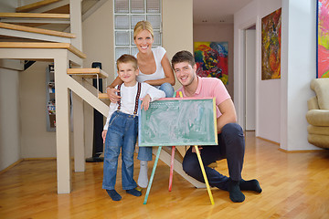 Image showing family drawing on school board at home