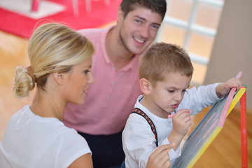 Image showing family drawing on school board at home