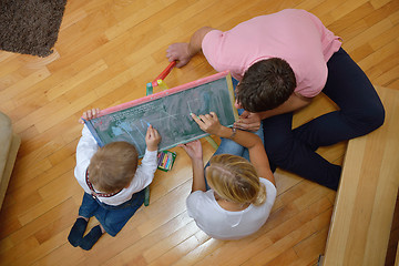 Image showing family drawing on school board at home