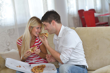 Image showing couple at home eating  pizza