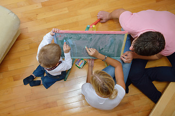 Image showing family drawing on school board at home