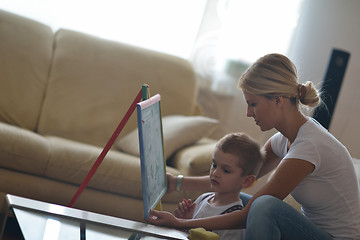 Image showing family drawing on school board at home