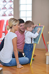 Image showing family drawing on school board at home