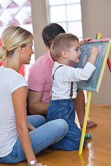 Image showing family drawing on school board at home